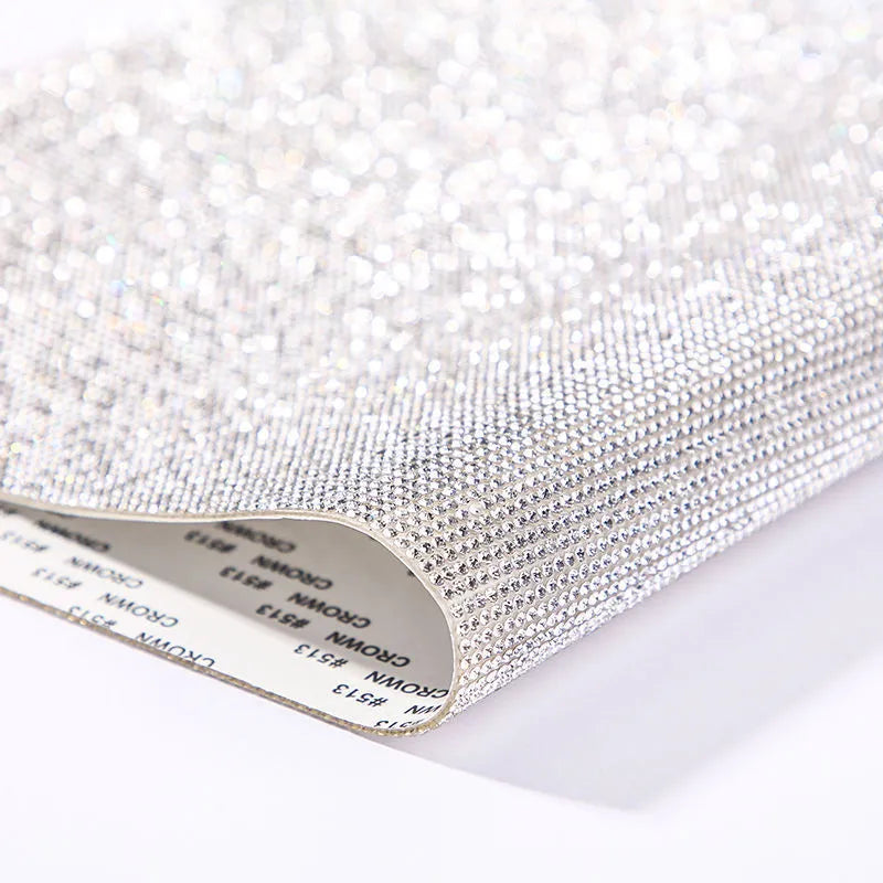 Rhinestone sticker net on backing sheet for hot drilling application to fabrics in multiple colour options