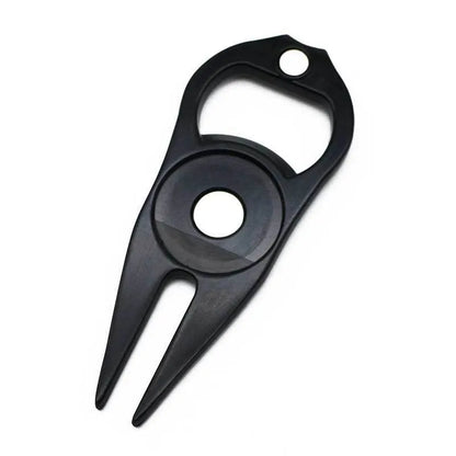 A black zinc alloy golf ball yoke tool with a bottle opener and a separate ball coin on a putting green.