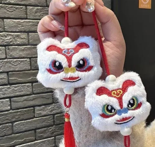 Blue and yellow Chinese style plush lion keychain ornament with star stone eyes and tassel.
