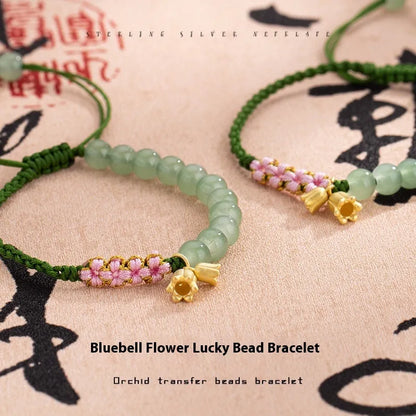 Hand woven red rope women's bracelet in Lily Carrying Strap colour with a flower element.
