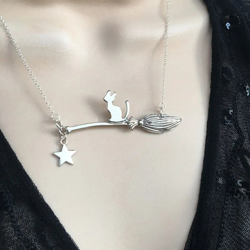 Black cat pendant necklace on a chain, available in silver and gold finishes.