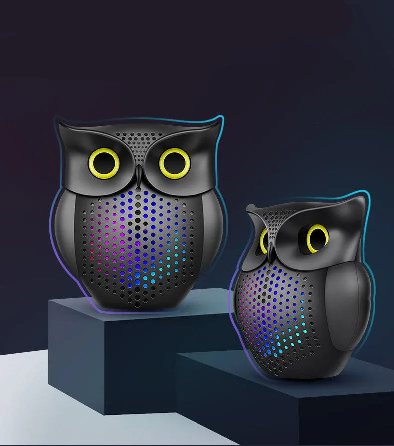 Black cartoon owl design wireless Bluetooth speaker on a surface.