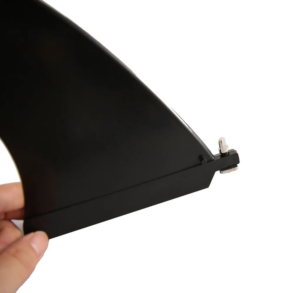 SUP paddle with detachable fish fins showing screw attachment system and plastic construction