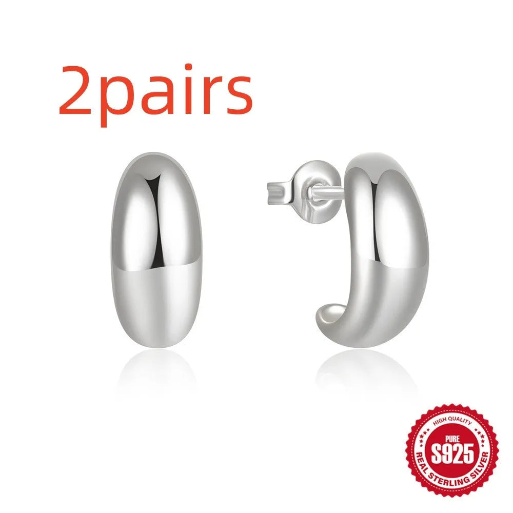 C-shaped sterling silver earrings with glossy electroplated finish in gold or white gold options