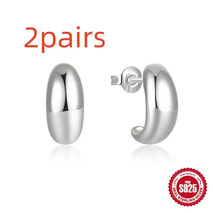 C-shaped sterling silver earrings with glossy electroplated finish in gold or white gold options