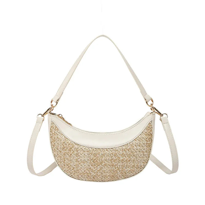 Women's hard-shell straw shoulder bag in a dumpling shape with a crossbody strap, shown in a choice of colours.