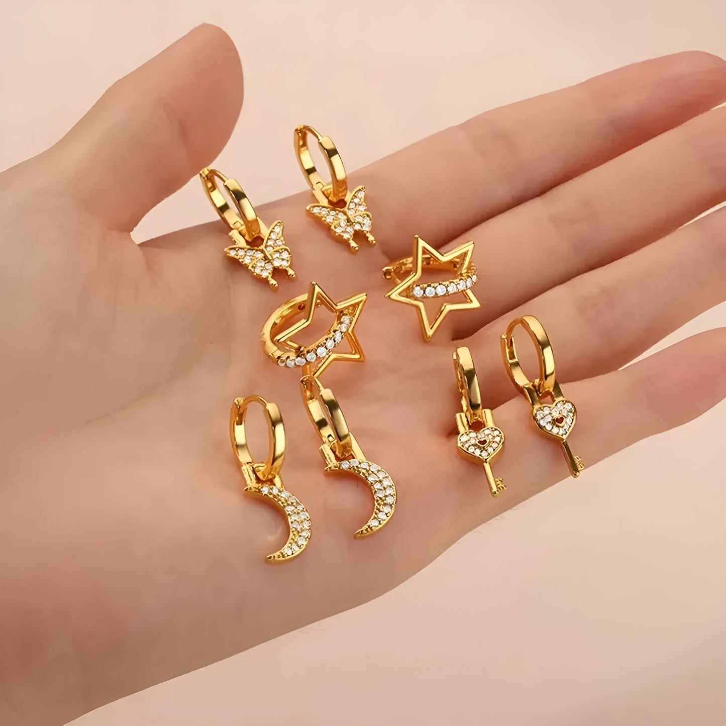 Women's irregular geometric butterfly earrings in copper with diamond treatment, showing heart-shaped and star designs in various colours
