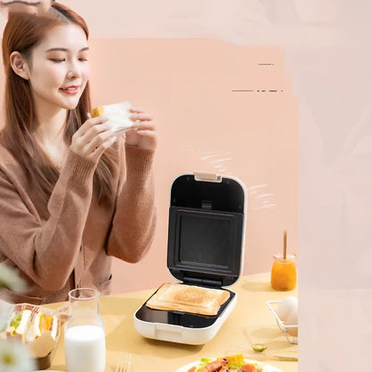 White mini breakfast machine with metal construction measuring 12x11cm for single-person cooking