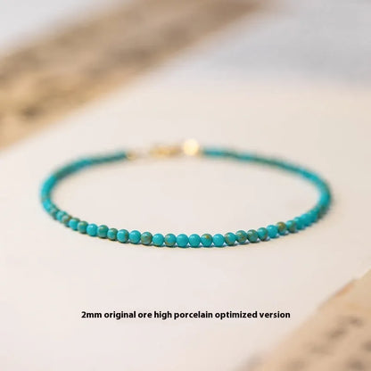 Close-up of a women's 2mm raw ore turquoise bracelet with geometric beads, showing its Chinese style and adjustable extension chain.