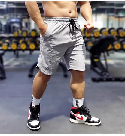 Men's thin quick-drying running shorts in black, blue, or grey, showing contrast colour detail.