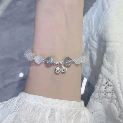 Chinese style glass bead bracelet with bamboo joint design on wrist.