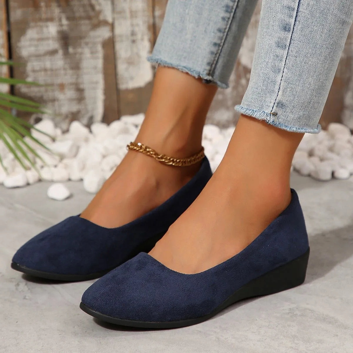 Women's black pointed toe wedge pumps with suede upper and low rubber sole