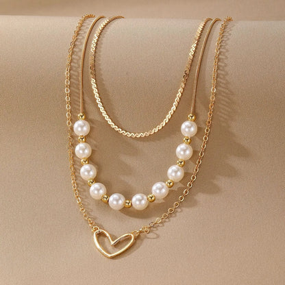 Vintage gold heart pendant necklace on a textured pearl chain, adjustable 41-50cm length.
