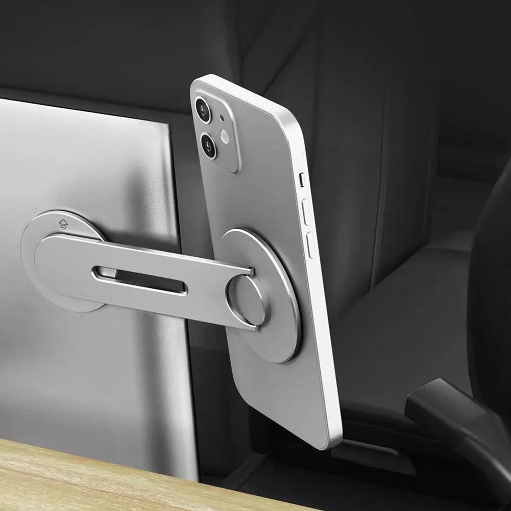 Silver magnetic phone holder mounted behind Tesla suspension screen showing 180-degree rotation adjustment