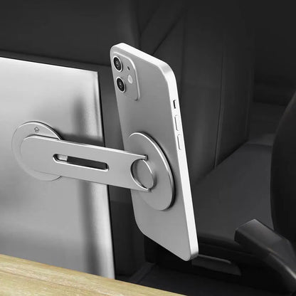 Silver magnetic phone holder mounted behind Tesla suspension screen showing 180-degree rotation adjustment