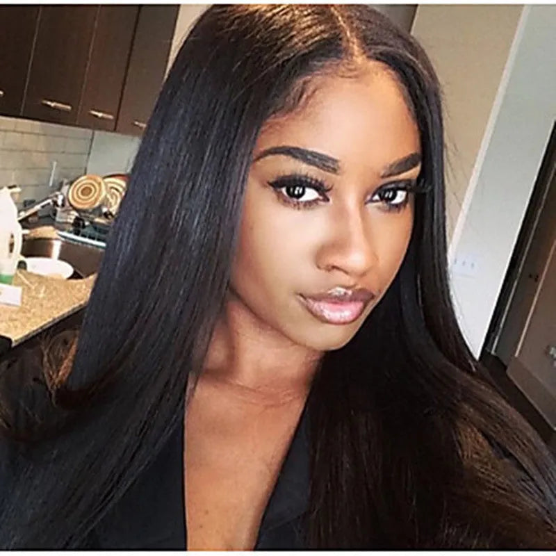 Long black straight synthetic wig on a stand, showing centre parting and full fringe