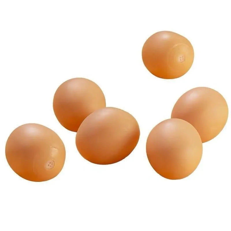 Pink rubber simulation egg dog toy with a textured surface for chewing.