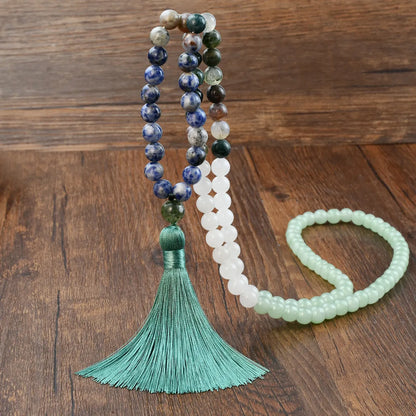 Long beaded necklace with geometric pendant and natural stone tassels in green aventurine.