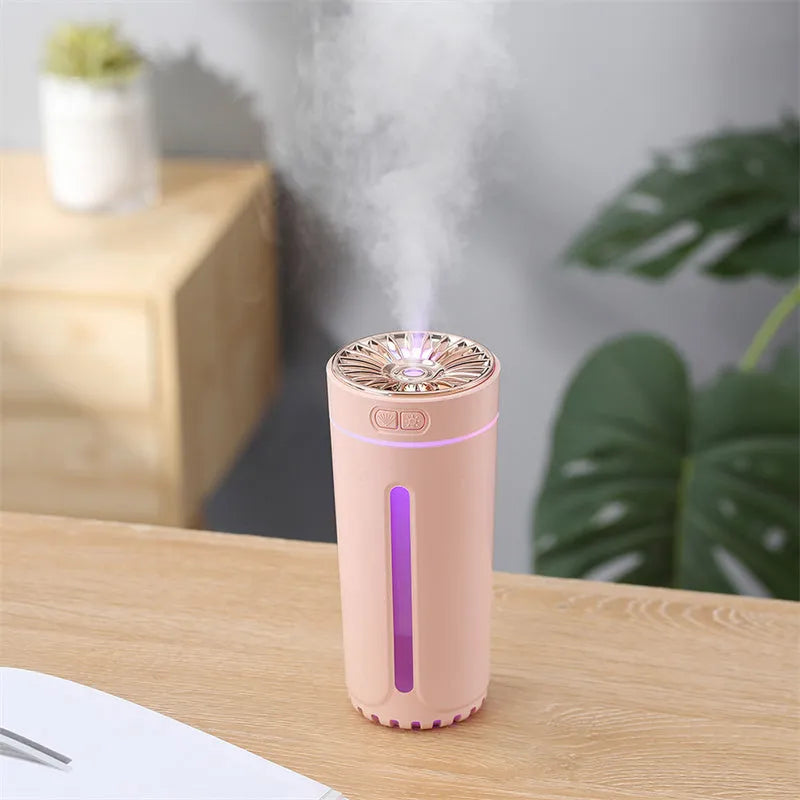Black wireless car humidifier with colourful LED lights shown in vehicle cup holder