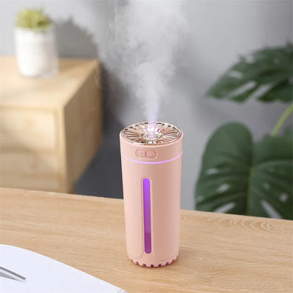 Black wireless car humidifier with colourful LED lights shown in vehicle cup holder