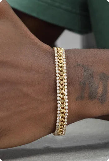 A gold-coloured unisex tennis bracelet with inlaid stones on a titanium steel band.