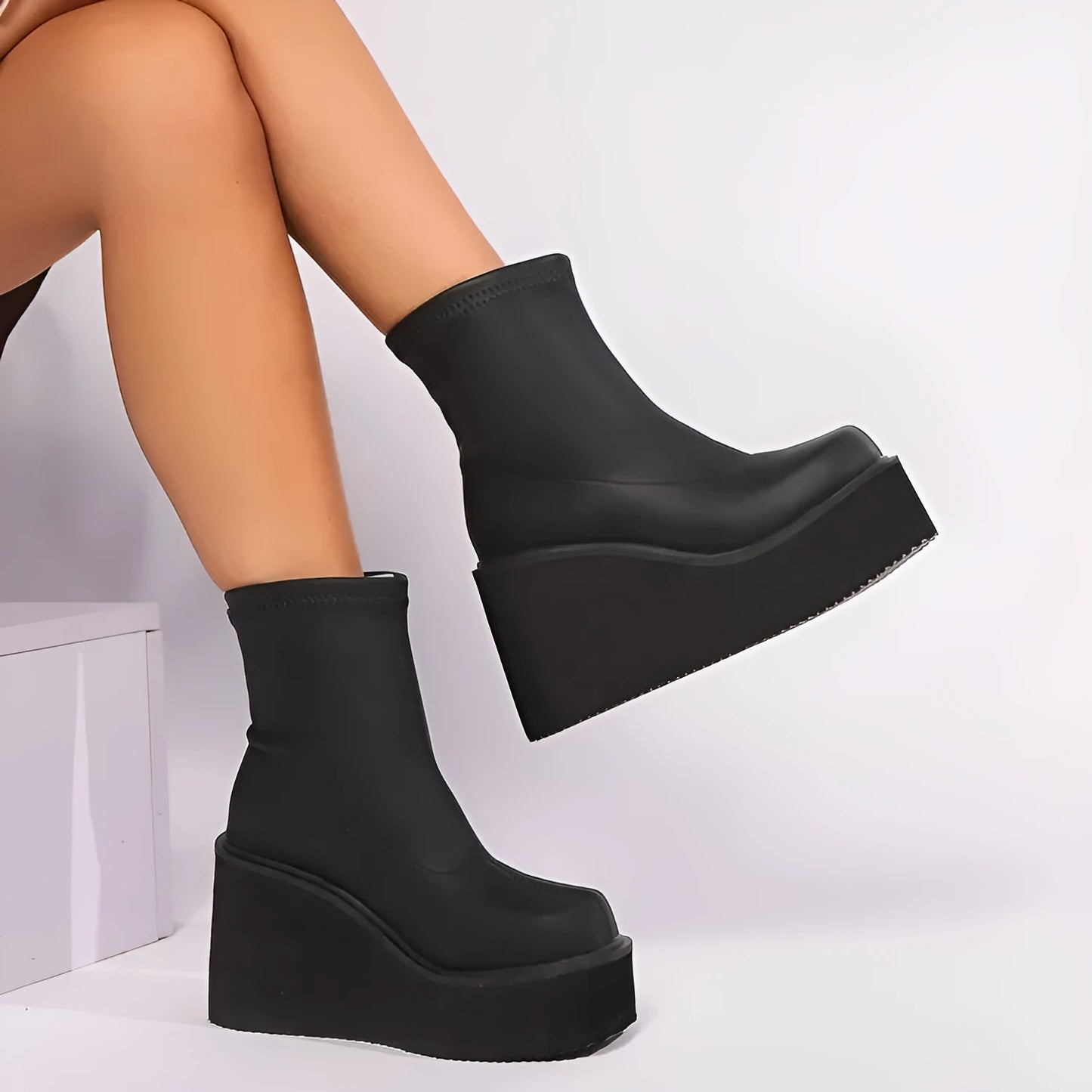 Plus size women's black wedge heel boots with round toe and waterproof platform sole.