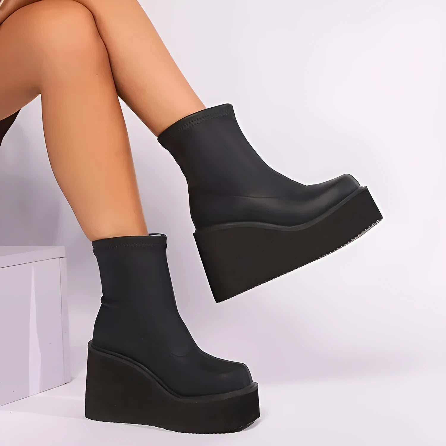 Plus size women's black wedge heel boots with round toe and waterproof platform sole.
