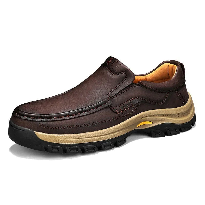 Men's black leather mountaineering shoes with thick rubber sole and round toe.