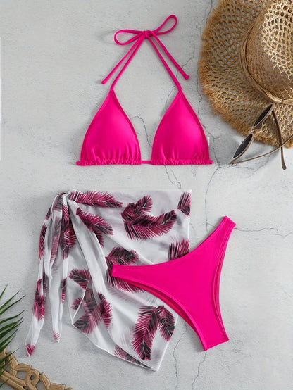 Women's orange three-piece bikini swimsuit with a matching printed gauze skirt laid flat.