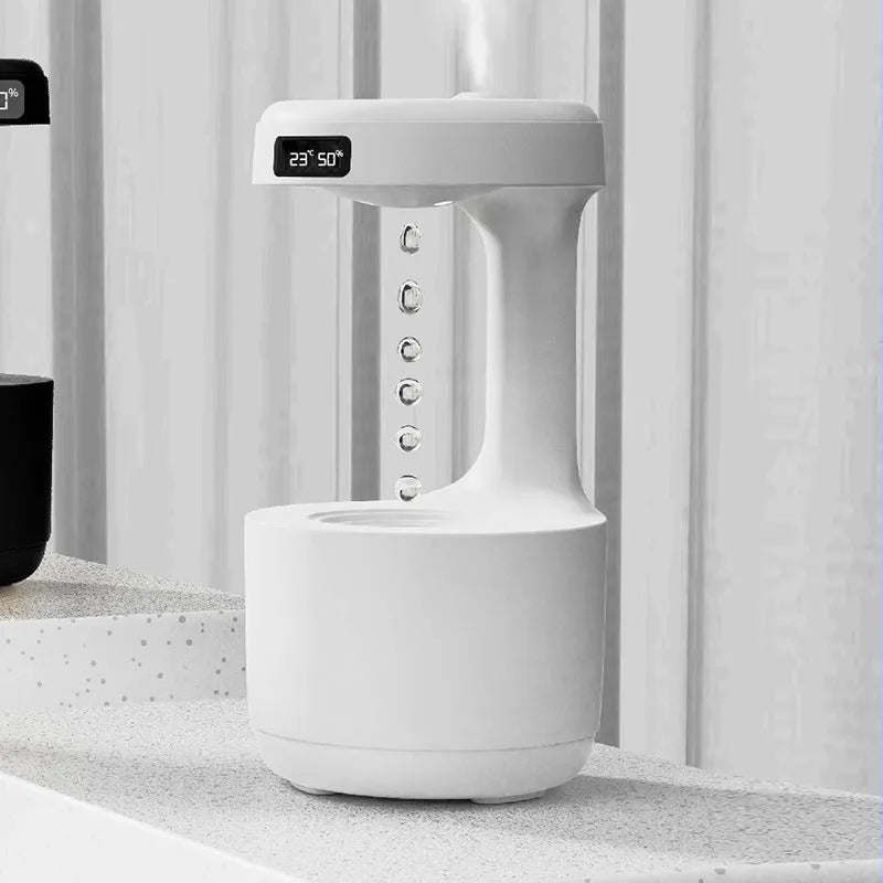 White columnar anti-gravity humidifier with LED clock display on a wooden desk