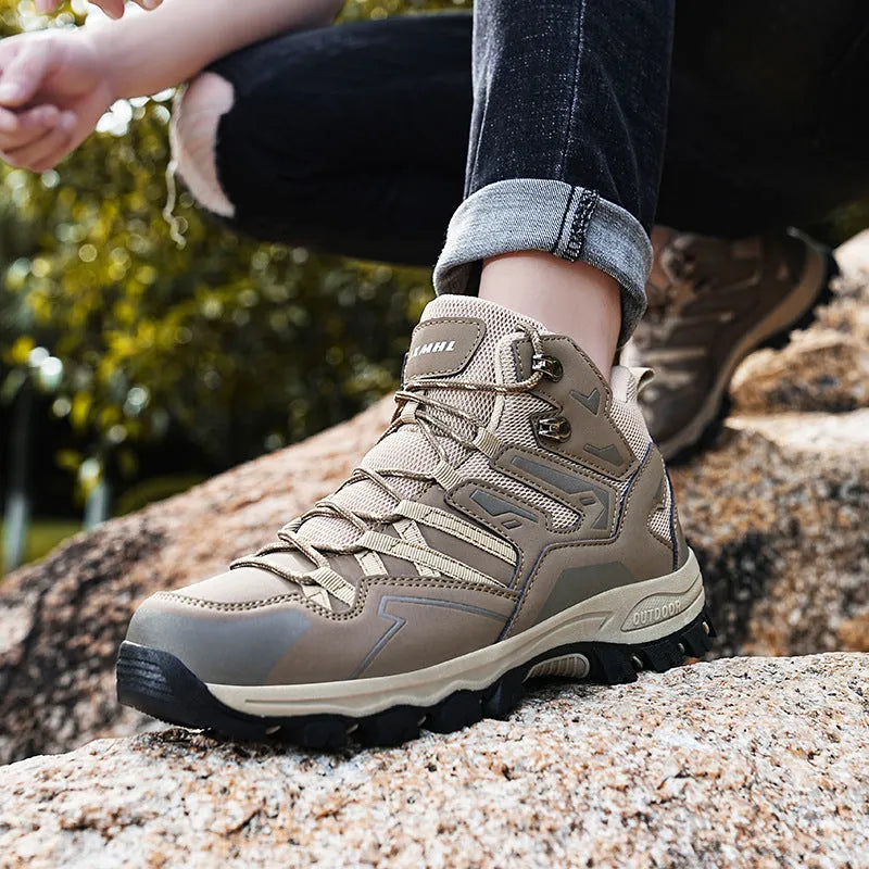 Low-top hiking sneaker in multiple colours on a rocky mountain path, showing lace-up front and rubber sole.