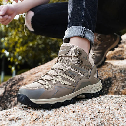 Low-top hiking sneaker in multiple colours on a rocky mountain path, showing lace-up front and rubber sole.