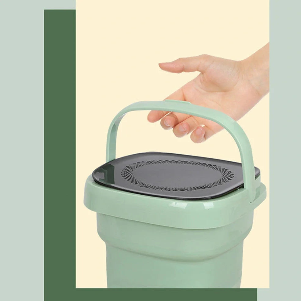 Green portable folding washing machine showing collapsed storage size and antibacterial blue light feature