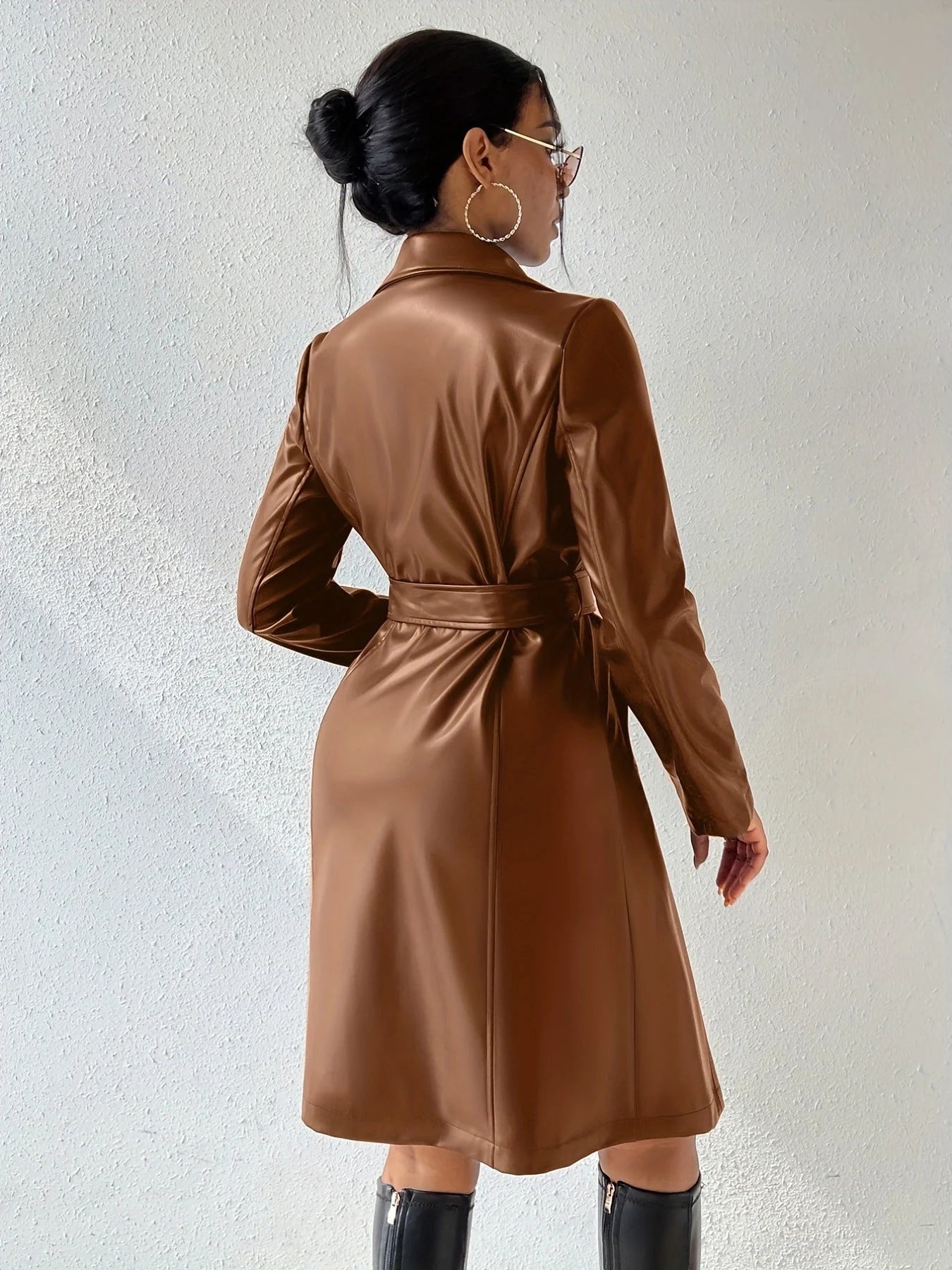 Women's long sleeve faux leather trench coat in various colors with pockets and slim fit design