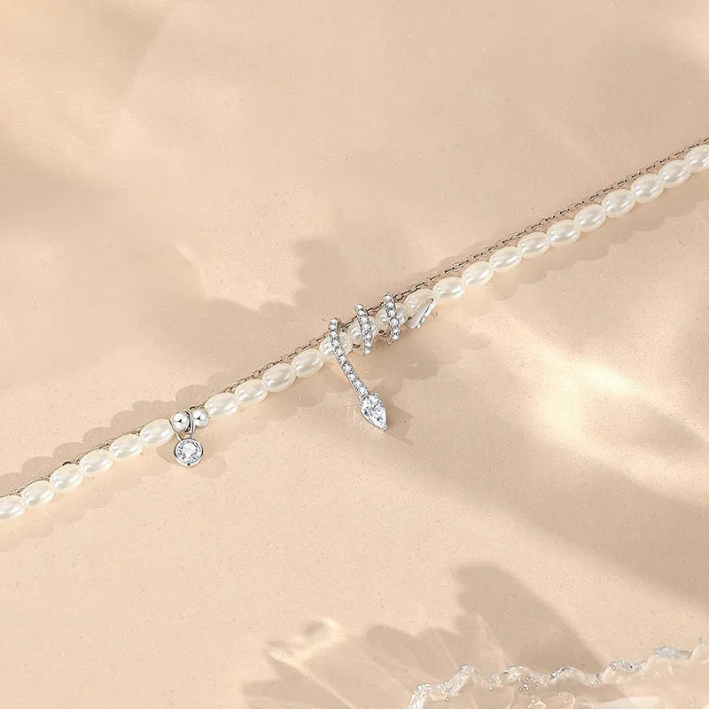 Pearl snake bracelet in 925 silver with electroplated gold or white gold finish and geometric animal design