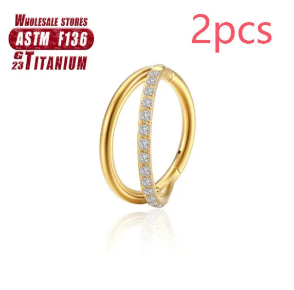Pair of titanium alloy nose rings on a plain background showing silver, gold, black, and rose gold colour options.