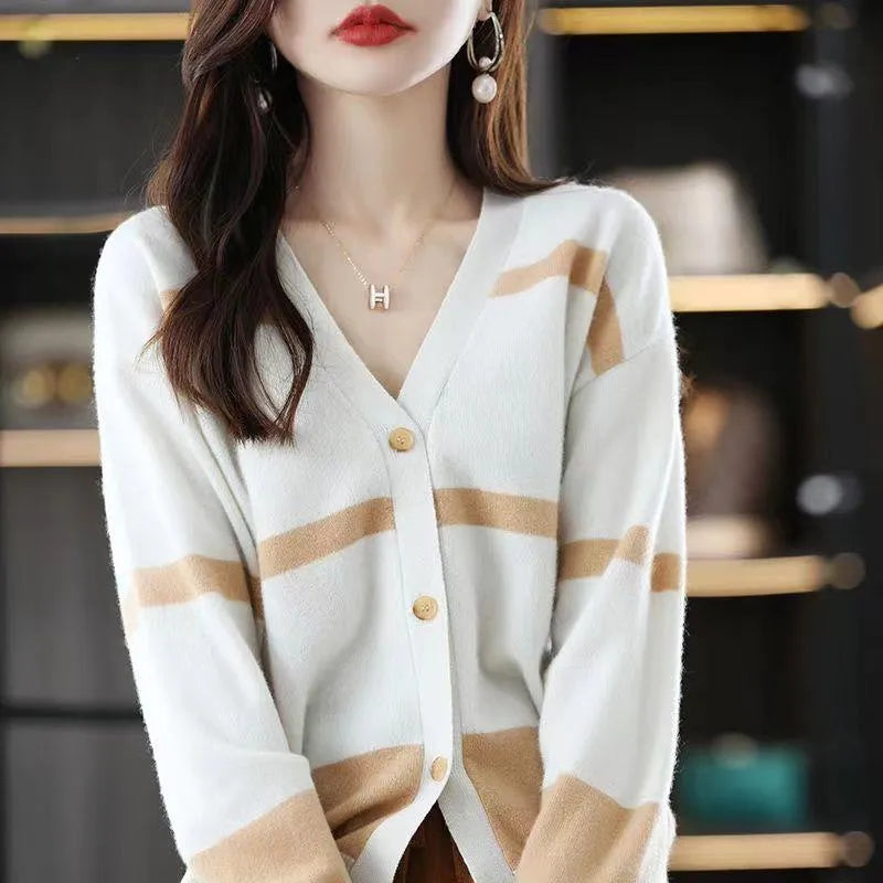 Women's black and white striped V-neck cardigan with buttons, showing a textured 3D knit pattern.
