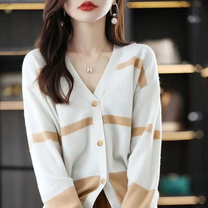 Women's black and white striped V-neck cardigan with buttons, showing a textured 3D knit pattern.