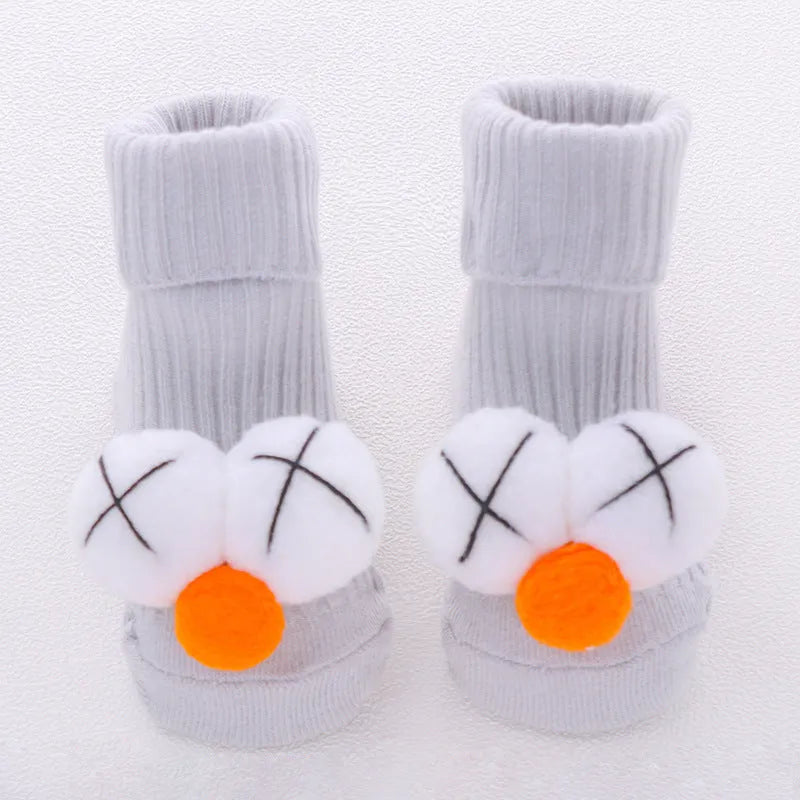 Cotton baby floor socks in assorted colours and patterns including bows, stars, and animal designs.