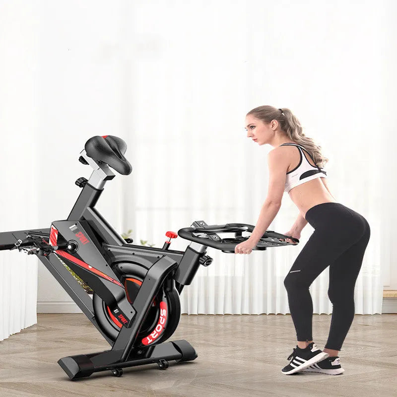 Black upright spinning bike with silent operation, infinite resistance adjustment, and display for distance, time, speed, and calories