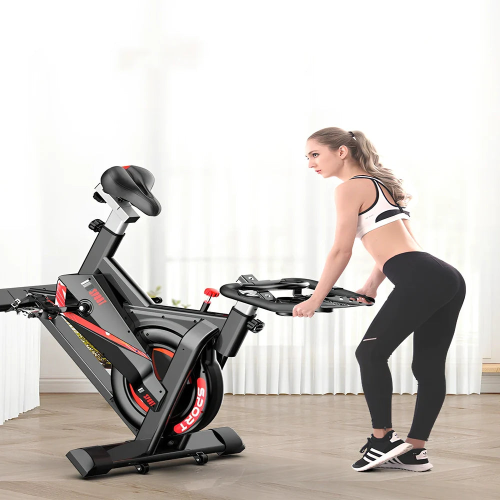 Black upright spinning bike with infinite resistance display for silent home fitness tracking distance and calories