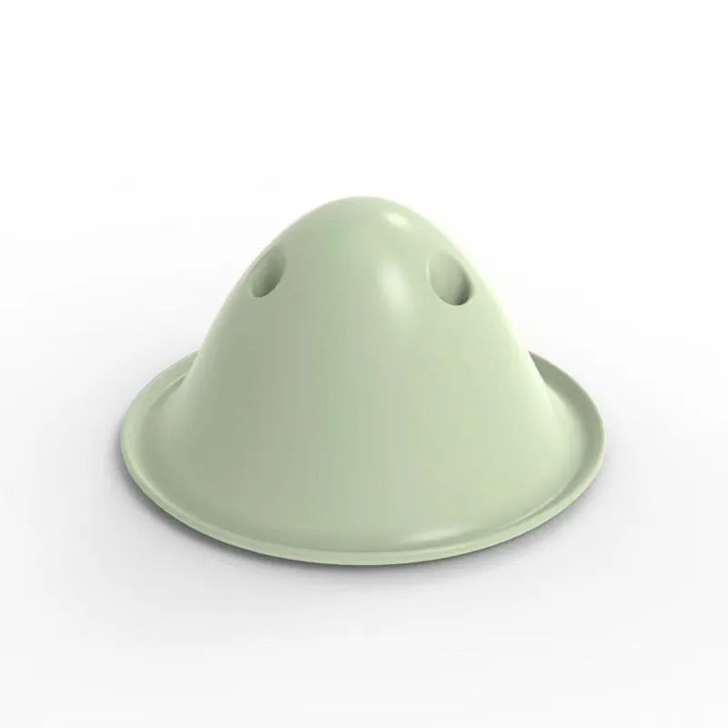 Green interactive dog chew puzzle toy with hidden treat slots on a flat base.