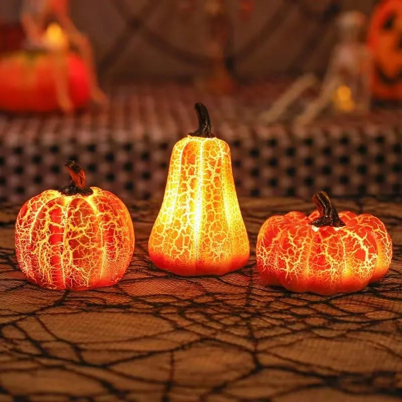 Set of three resin Halloween pumpkin lanterns with LED lights in long, medium, and short sizes.
