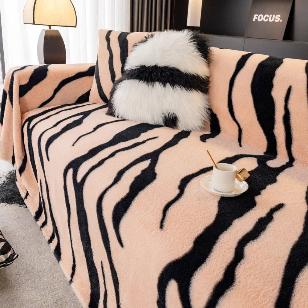 Zebra pattern sofa cover cloth in flannel fabric with non-slip backing, shown in caramel colour on a sofa