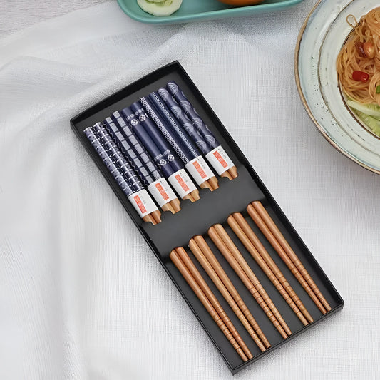 Set of five pairs of bamboo chopsticks showing lucky cat and chi ya blue pattern designs in gift box.