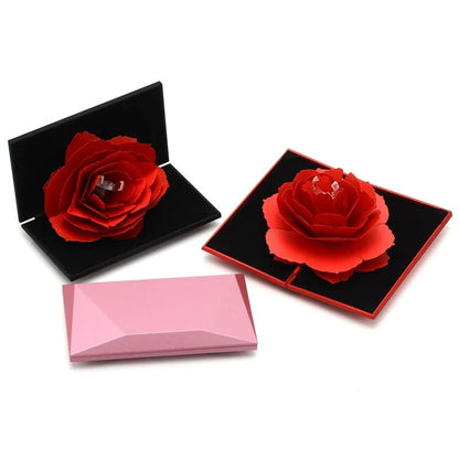 Red 3D heart-shaped plastic ring box with rose decoration on a rotating stand