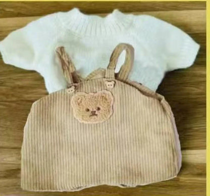 30cm doll clothing collection showing multiple outfit pieces including hooded jackets, sweaters, and suspender pants