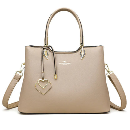 Women's black PU leather messenger bag with multi-layer shoulder strap and sewing thread detailing.