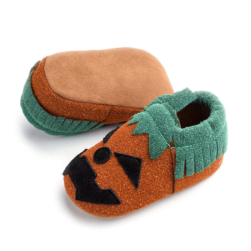 Adorable pumpkin-themed baby shoes with soft suede upper and non-slip canvas sole, available in vibrant yellow color and range of sizes
