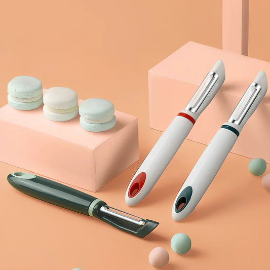 Stainless steel vegetable peeler with PP handle in aquamarine colour showing blade and grater functions